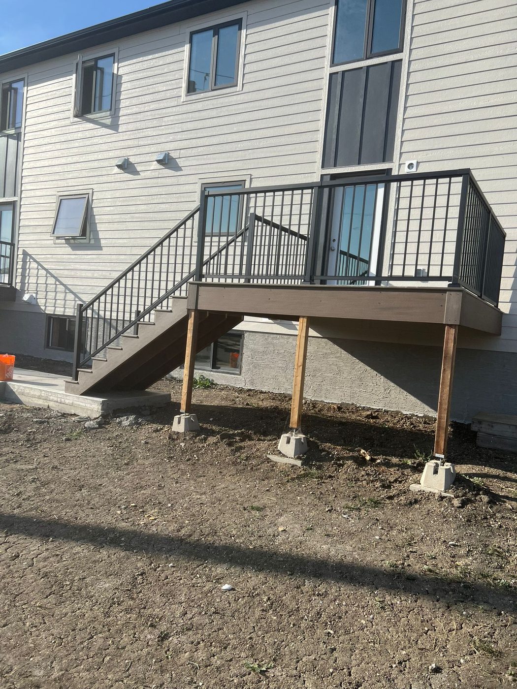 Composite deck with black metal railing and stairs Regina SK