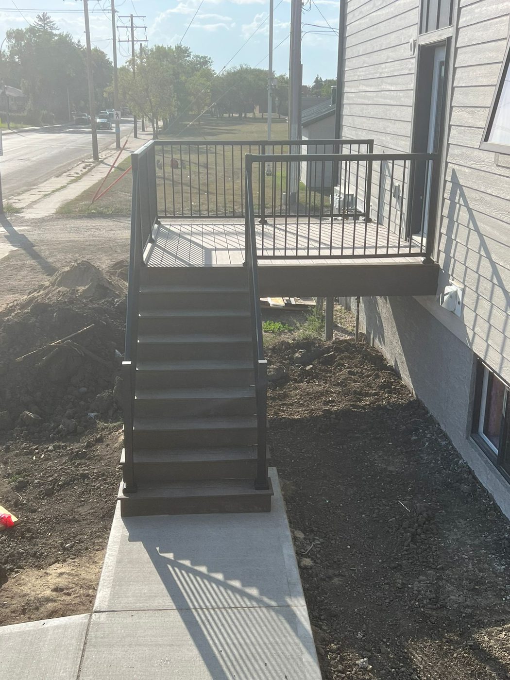 Deck build with black metal railing and stairs Regina SK