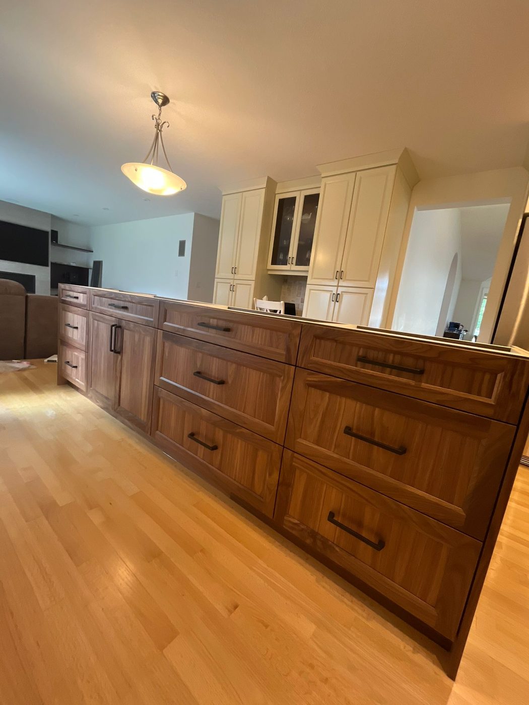 Walnut kitchen island with white upper cabinets finished Regina SK