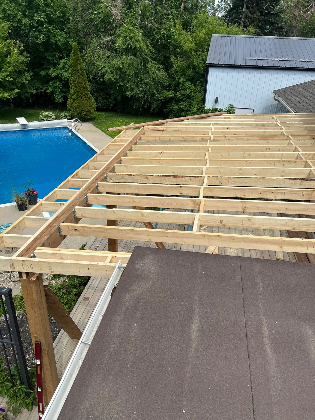 Deck framing build with pool in background Regina SK