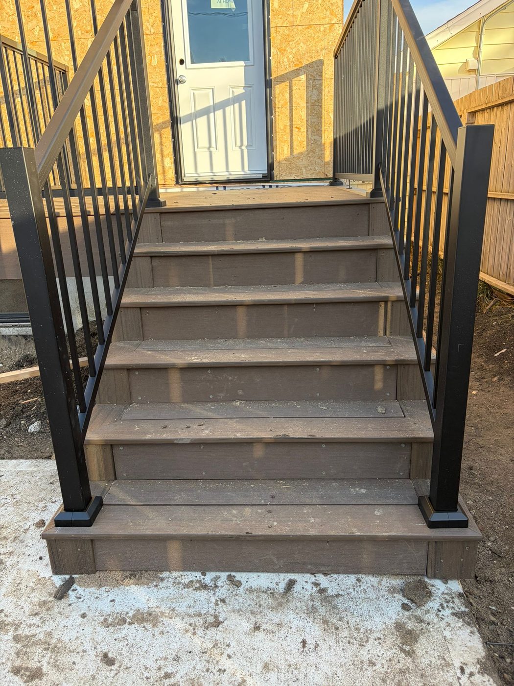 Composite stair build with black metal railing Regina SK