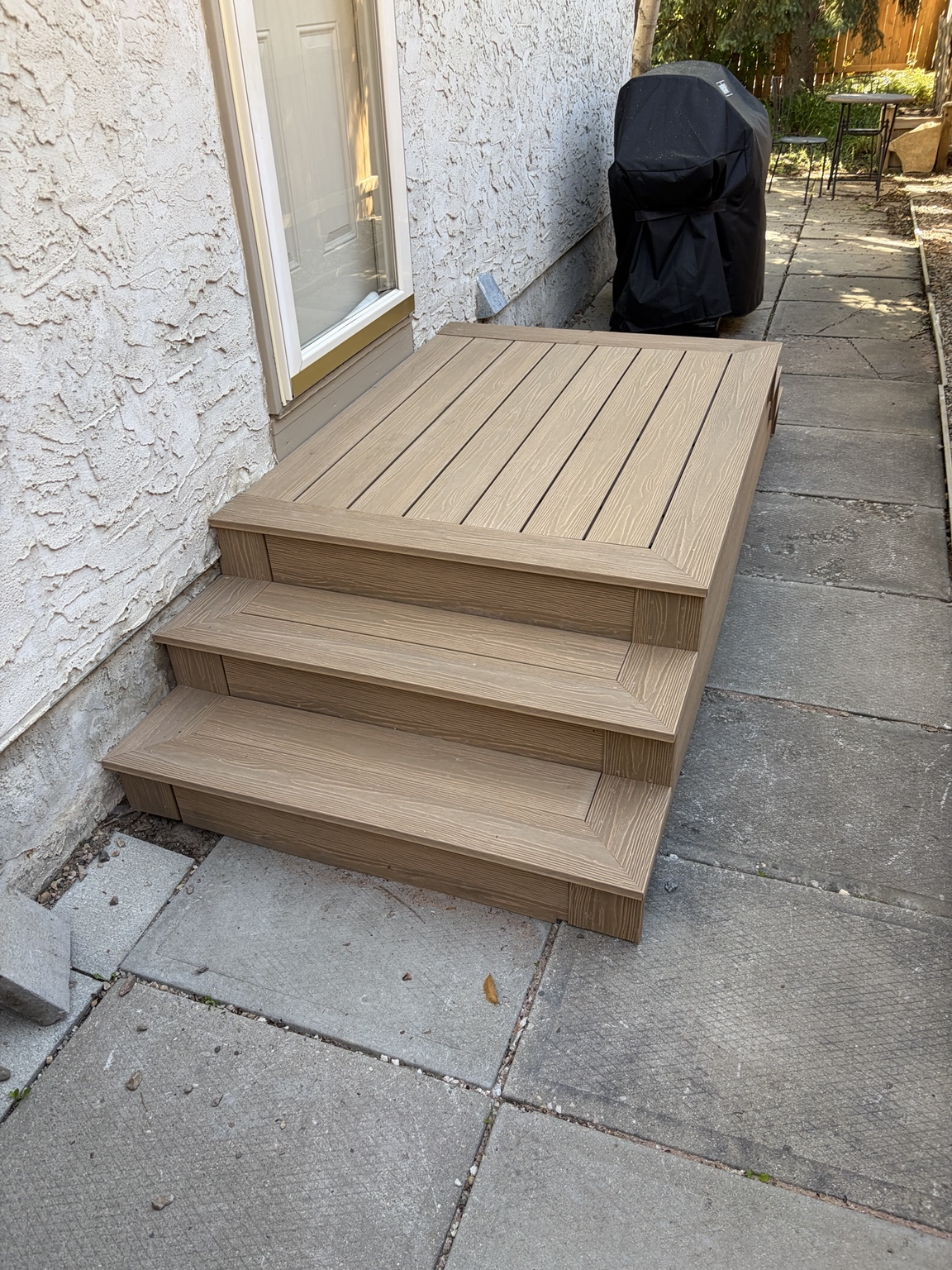 Completed composite entry steps outside a rear door