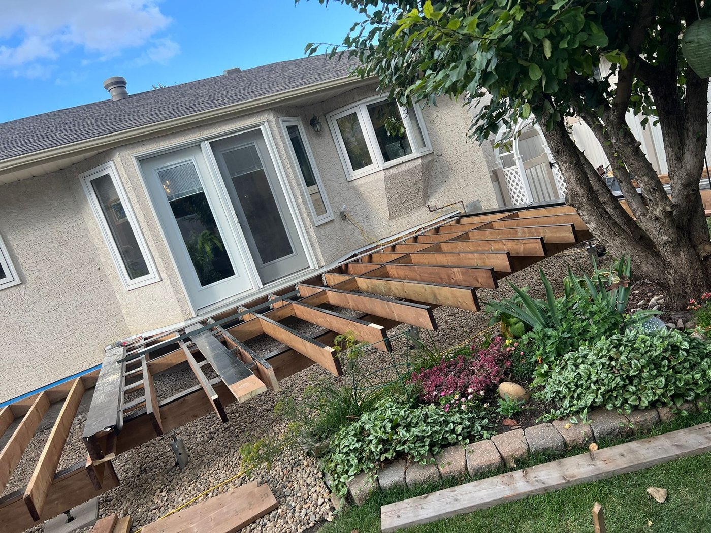 Deck framing beside a home during construction